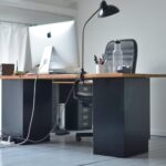 office table with computer and big chair in workplace