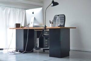 office table with computer and big chair in workplace